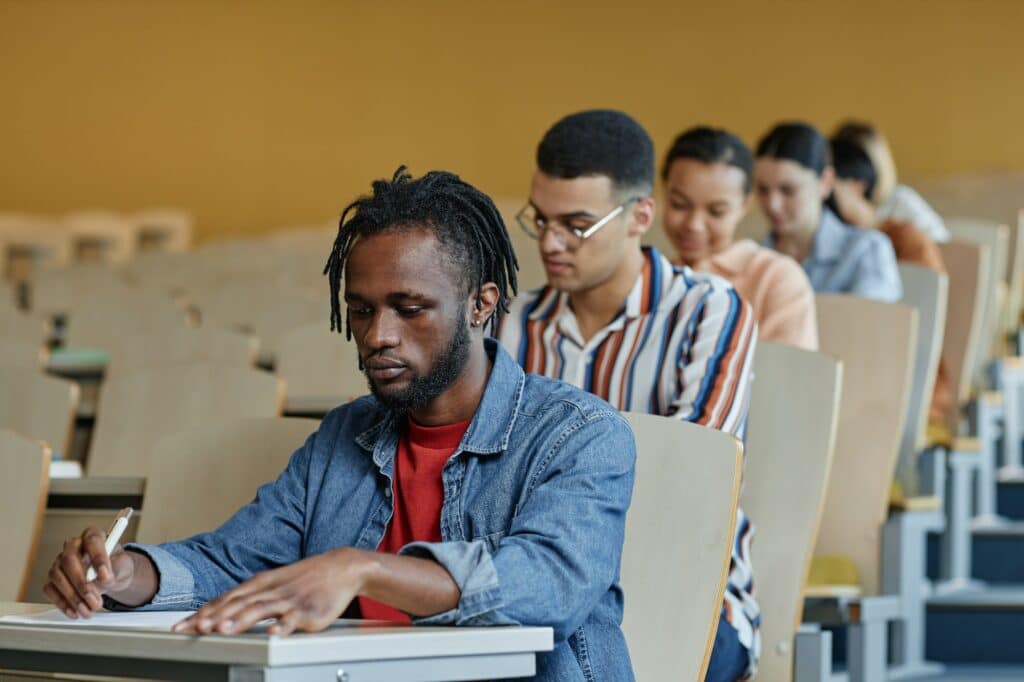 International students sitting at a desk at a lecture - international student scholarships